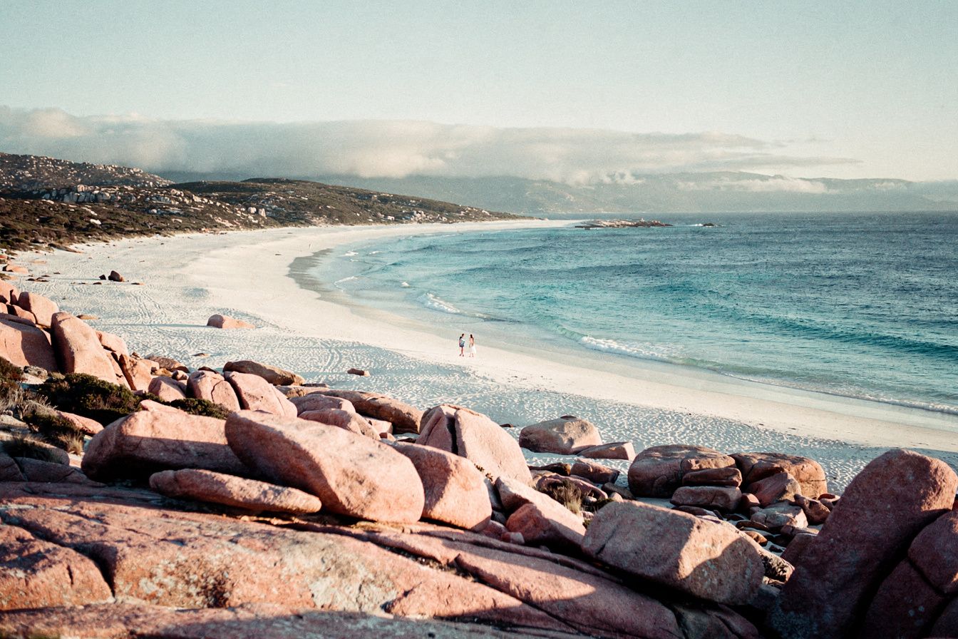 Pink granite boulders, a white crescent beach and turquoise water at Freycinet, Tasmania